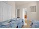 Bright bedroom features two twin beds and a closet, with easy access to the ensuite bathroom at 1031 Marcello Blvd, Kissimmee, FL 34746
