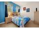 Bedroom featuring a blue cartoon themed bedding, blue walls, and two bedside tables at 1031 Marcello Blvd, Kissimmee, FL 34746