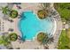 Aerial view showcasing a beautifully landscaped community pool area with chairs, tables, and lush tropical plants at 1031 Marcello Blvd, Kissimmee, FL 34746