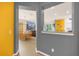 View of the dining room and living area featuring a vibrant yellow accent wall and modern decor at 1031 Marcello Blvd, Kissimmee, FL 34746