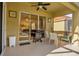 Covered outdoor patio space with a BBQ grill, dining table, and a view to the dining room at 1031 Marcello Blvd, Kissimmee, FL 34746