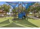 Modern playground area featuring soft turf and various play structures under a shade canopy at 1031 Marcello Blvd, Kissimmee, FL 34746