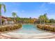 Beautiful community pool area surrounded by palm trees and lounge chairs at 1031 Marcello Blvd, Kissimmee, FL 34746