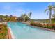 Resort-style pool area featuring lush landscaping, pergola, and plenty of lounge seating at 1031 Marcello Blvd, Kissimmee, FL 34746