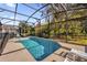 Private screened-in pool with lounge chairs, and views to the natural backyard at 1031 Marcello Blvd, Kissimmee, FL 34746