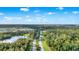 Aerial view showing a community road lined with trees surrounded by lush green vegetation at 1089 Blue Jay Dr, Davenport, FL 33837