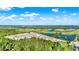 Aerial view of townhomes nestled among trees and ponds in a well-manicured golf community at 1089 Blue Jay Dr, Davenport, FL 33837