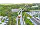 Aerial view showcasing the community entrance nestled among trees, residences, and lush green landscaping at 1089 Blue Jay Dr, Davenport, FL 33837