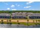 An aerial view showcases the community homes backing up to the lake at 1089 Blue Jay Dr, Davenport, FL 33837