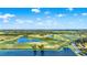 Wide aerial view of a lush golf course community with multiple ponds and mature trees at 1089 Blue Jay Dr, Davenport, FL 33837