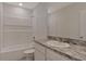Bathroom features granite counters, white tile, large mirror and a shower/tub combo at 1089 Blue Jay Dr, Davenport, FL 33837