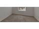 This neutral bedroom has a large window providing ample light and a great view at 1089 Blue Jay Dr, Davenport, FL 33837