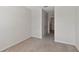This carpeted bedroom has neutral walls, trim and a door leading to another room at 1089 Blue Jay Dr, Davenport, FL 33837