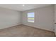 This spacious bedroom has neutral walls and trim and a view of the lake at 1089 Blue Jay Dr, Davenport, FL 33837