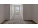 This bedroom has neutral walls and carpet, a large window and a white door at 1089 Blue Jay Dr, Davenport, FL 33837