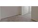 This bedroom has neutral carpet, trim and walls, with a closet to the right at 1089 Blue Jay Dr, Davenport, FL 33837