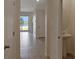View from entryway of the living space with tile floors and sliding glass doors to the lake at 1089 Blue Jay Dr, Davenport, FL 33837