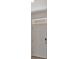 View of the neutral white, six-panel front door with a peep hole and a window above at 1089 Blue Jay Dr, Davenport, FL 33837