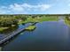 Scenic golf course featuring a lake and a wooden bridge on a sunny day with blue skies at 1089 Blue Jay Dr, Davenport, FL 33837
