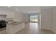 An open-concept kitchen features white cabinets, a granite-topped island, and stainless-steel appliances at 1089 Blue Jay Dr, Davenport, FL 33837
