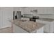A spacious kitchen with a large island, stainless-steel appliances, and white cabinets at 1089 Blue Jay Dr, Davenport, FL 33837