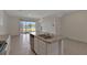 Open concept kitchen with island overlooks living area with sliding glass doors providing beautiful lake views at 1089 Blue Jay Dr, Davenport, FL 33837