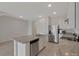 Bright kitchen features stainless steel appliances, granite countertops, and a center island with a sink and dishwasher at 1089 Blue Jay Dr, Davenport, FL 33837