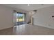 Spacious living room with large sliding glass doors, staircase, and access to kitchen area at 1089 Blue Jay Dr, Davenport, FL 33837