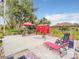Spacious backyard provides a firepit, lounge chairs, cabana and colorful shed at 1105 Tivoli Drive, Deltona, FL 32725