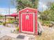 Backyard shed provides additional storage and is decorated with a unique art piece at 1105 Tivoli Drive, Deltona, FL 32725