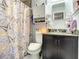 Bathroom featuring a granite countertop, a toilet and a shower with patterned curtain at 1105 Tivoli Drive, Deltona, FL 32725