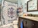 Bathroom featuring a sink with granite countertop, a toilet and a shower with patterned curtain at 1105 Tivoli Drive, Deltona, FL 32725