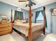 Spacious bedroom with four-poster bed, dresser, and dark teal curtains offering a relaxing atmosphere at 1105 Tivoli Drive, Deltona, FL 32725