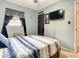 View of the bedroom featuring a ceiling fan, mounted television and a window with curtains at 1105 Tivoli Drive, Deltona, FL 32725
