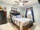View of the bedroom featuring a ceiling fan, closet and a full bed with drawers at 1105 Tivoli Drive, Deltona, FL 32725
