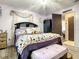 Light-filled bedroom featuring decorative pillows, ceiling fan and a door that leads to a room at 1105 Tivoli Drive, Deltona, FL 32725