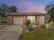Charming brick home features a well-maintained lawn, garden, and inviting front entrance at 1105 Tivoli Drive, Deltona, FL 32725