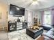 Relaxing living room with a large television, plush rug, and comfortable seating arrangement for entertaining guests at 1105 Tivoli Drive, Deltona, FL 32725
