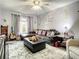 Cozy living room featuring a plush rug, comfortable sectional sofa, and soft natural light creating a welcoming atmosphere at 1105 Tivoli Drive, Deltona, FL 32725