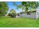 A backyard with a lush lawn, mature trees, and privacy for outdoor activities at 1108 Jordan Ave, Orlando, FL 32809