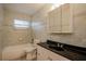 A bathroom with tiled walls, a window for natural light, and updated fixtures at 1108 Jordan Ave, Orlando, FL 32809