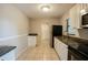 Functional kitchen features granite countertops and white cabinetry at 1108 Jordan Ave, Orlando, FL 32809