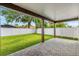 A spacious backyard features a covered patio with a brick floor and a well-manicured lawn at 1109 Naples Dr, Orlando, FL 32804