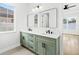 Bathroom featuring double vanity with sage green cabinets, modern fixtures, and ample natural light at 1109 Naples Dr, Orlando, FL 32804
