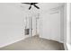 Bedroom with carpet, closet, and a door leading to an ensuite bathroom at 1109 Naples Dr, Orlando, FL 32804