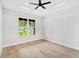 Spacious bedroom with tray ceilings, a large window, and hardwood floors at 1109 Naples Dr, Orlando, FL 32804