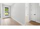 Welcoming entryway with wood flooring, a glass front door, and neutral walls at 1109 Naples Dr, Orlando, FL 32804