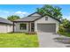 Beautiful exterior with nice landscaping, gray brick driveway, neutral colors, modern design, and covered front porch at 1109 Naples Dr, Orlando, FL 32804