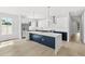Bright kitchen with hardwood floors, stainless steel appliances, white countertops, and dark navy base cabinets at 1109 Naples Dr, Orlando, FL 32804