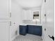 Bright laundry room showcases stylish cabinets, white countertops, and geometric tile flooring at 1109 Naples Dr, Orlando, FL 32804
